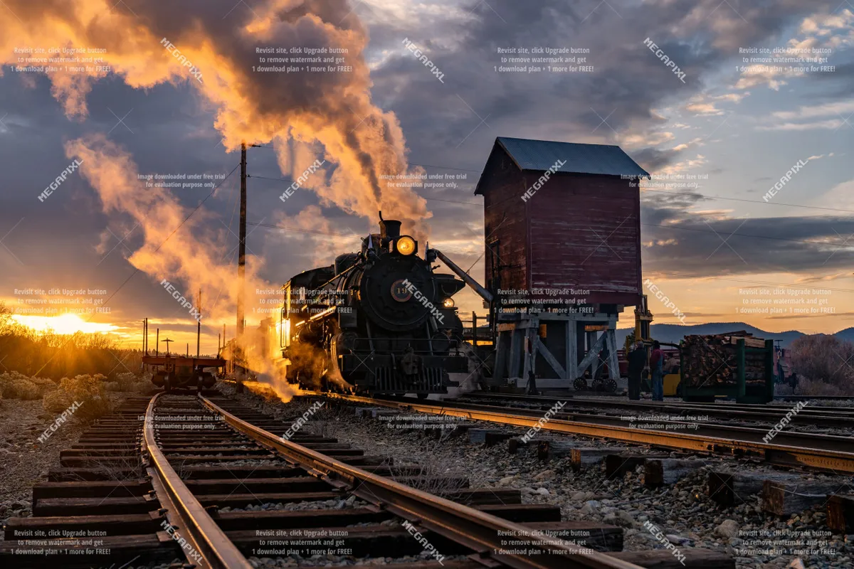 A striking scene featuring a steam locomotive, wooden water tower, railway tracks, and a sunset sky. The image evokes a sense of Baker City's historic charm and the allure of its railroading past.
